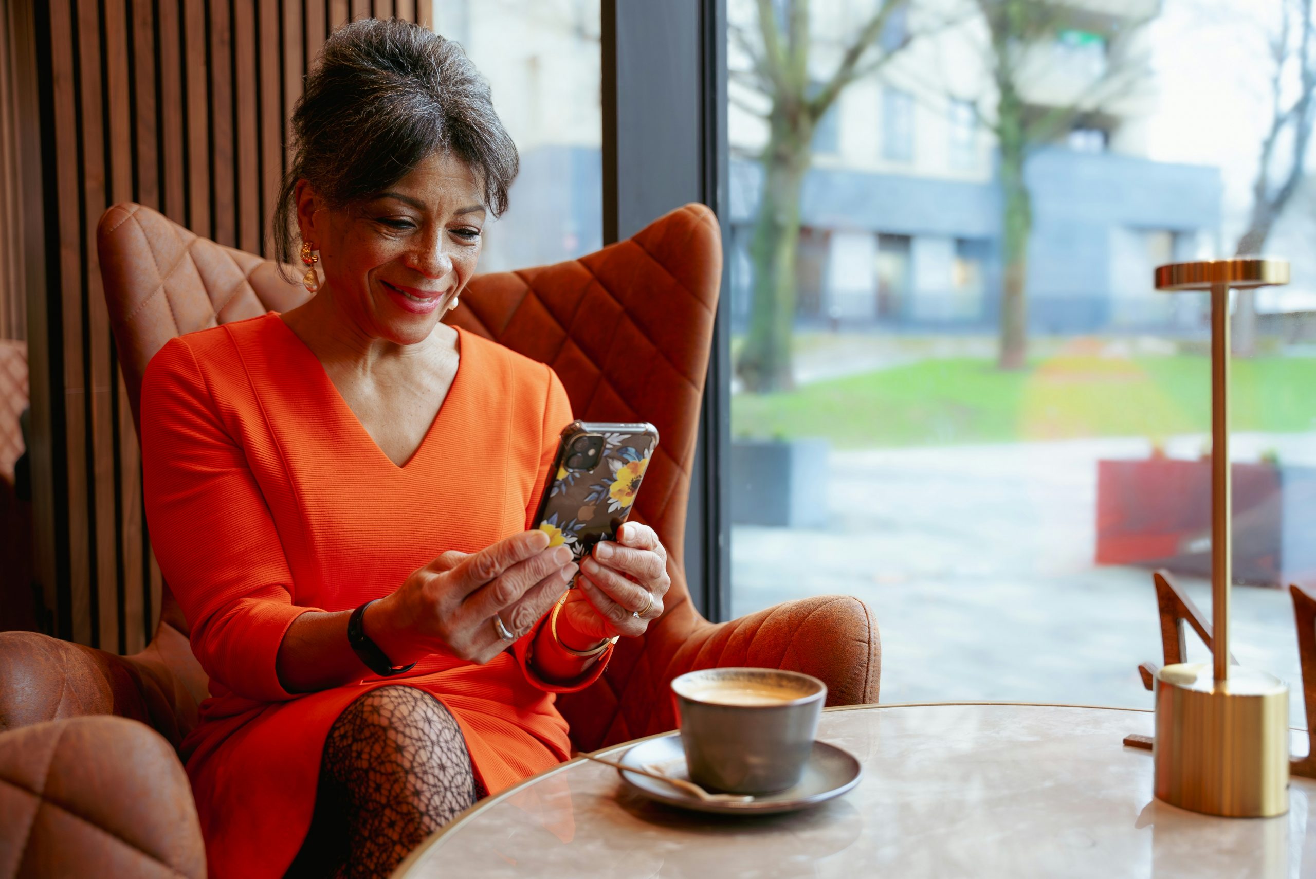 Senior man engages in a video conference with a colleague on a laptop, discussing documents.